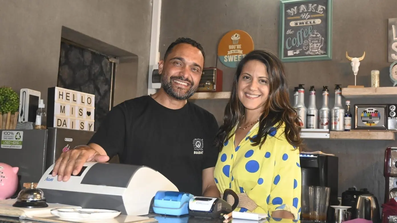 The owners of Miss Daisy behind the counter